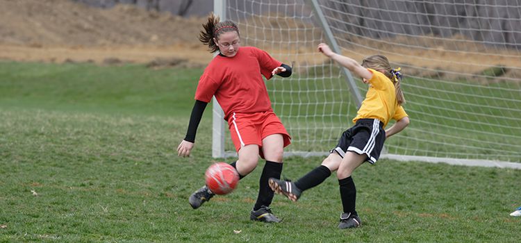 Tween girls playing soccer