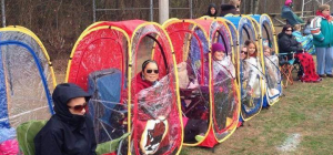 people watching the game in 1-person viewing tents